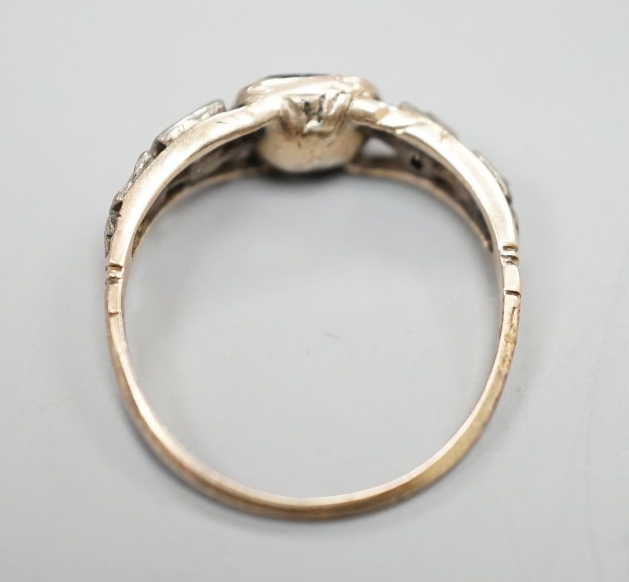 A 19th century yellow metal, garnet and diamond set five stone half hoop ring, size M, gross weight 1.7 grams.